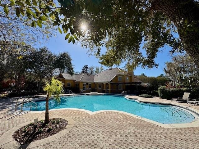 8842 Villa View Circle, Unit 108 Orlando, FL 32821 - Photo 16 of 25 a front view of a house with a yard and trees