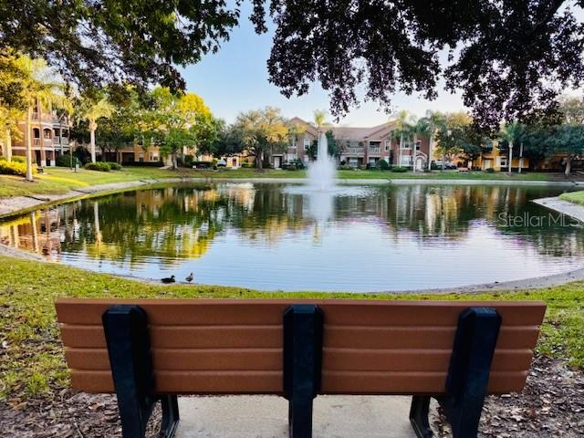 8842 Villa View Circle, Unit 108 Orlando, FL 32821 - Photo 17 of 25 a view of a lake with a table and chairs