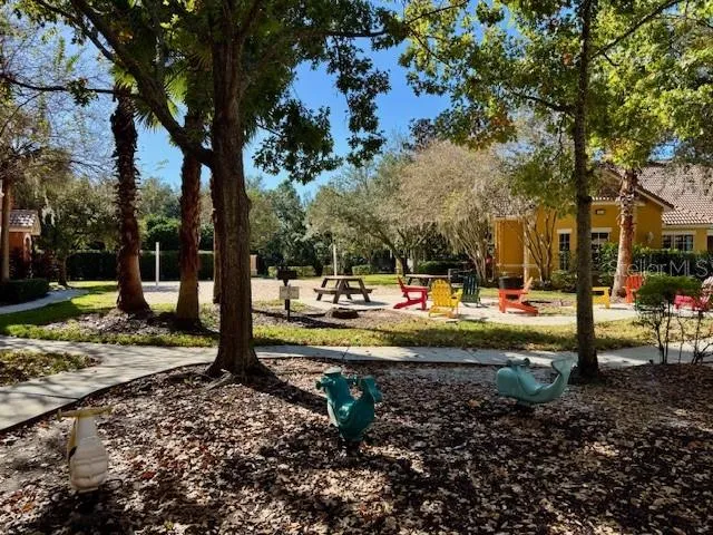 a view of a patio with lawn chairs wooden floor and fence
