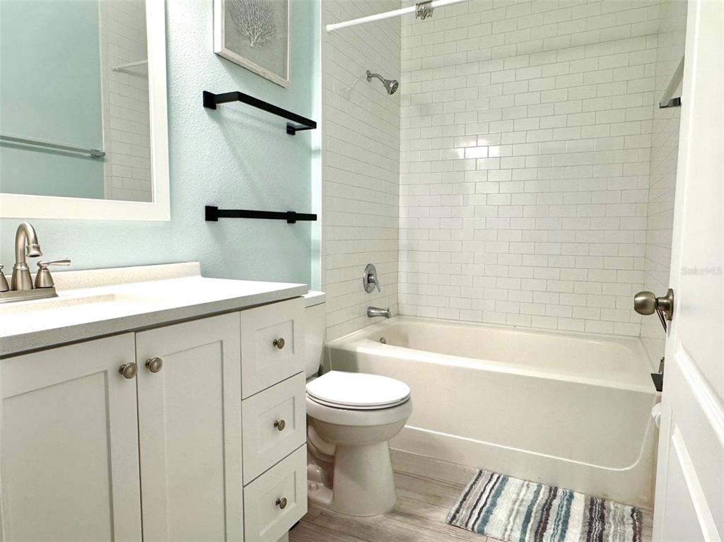 8842 Villa View Circle, Unit 108 Orlando, FL 32821 - Photo 9 of 25 a bathroom with a sink a toilet and a bathtub