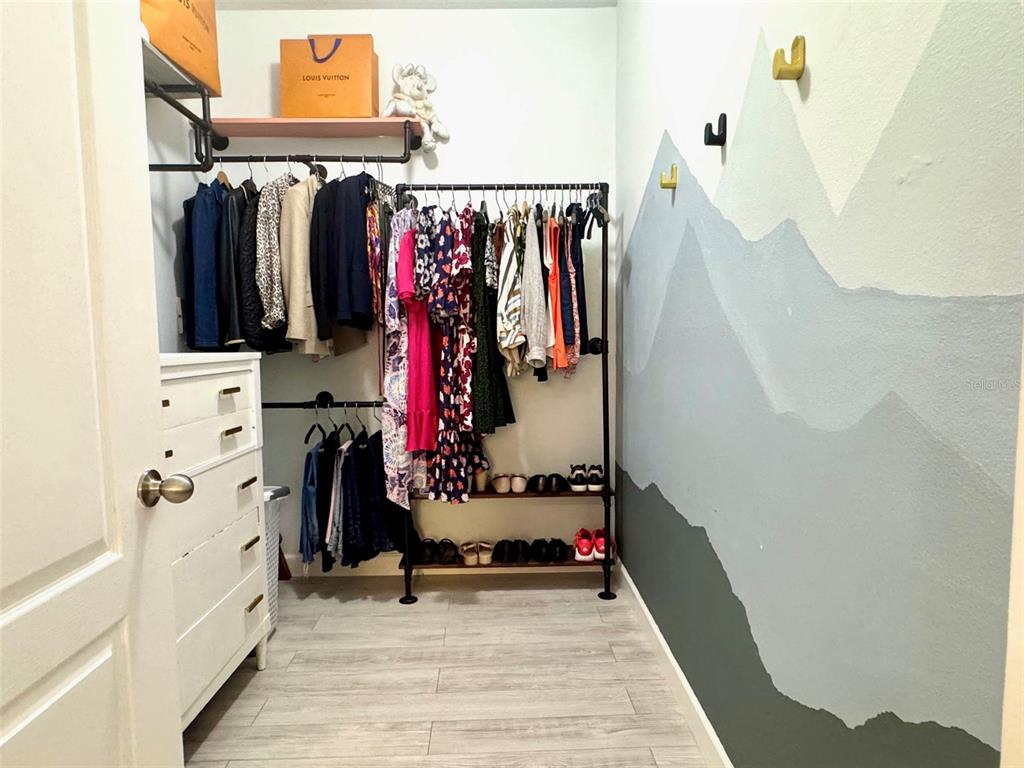 8842 Villa View Circle, Unit 108 Orlando, FL 32821 - Photo 10 of 25 a view of walk in closet with clothes and shoes