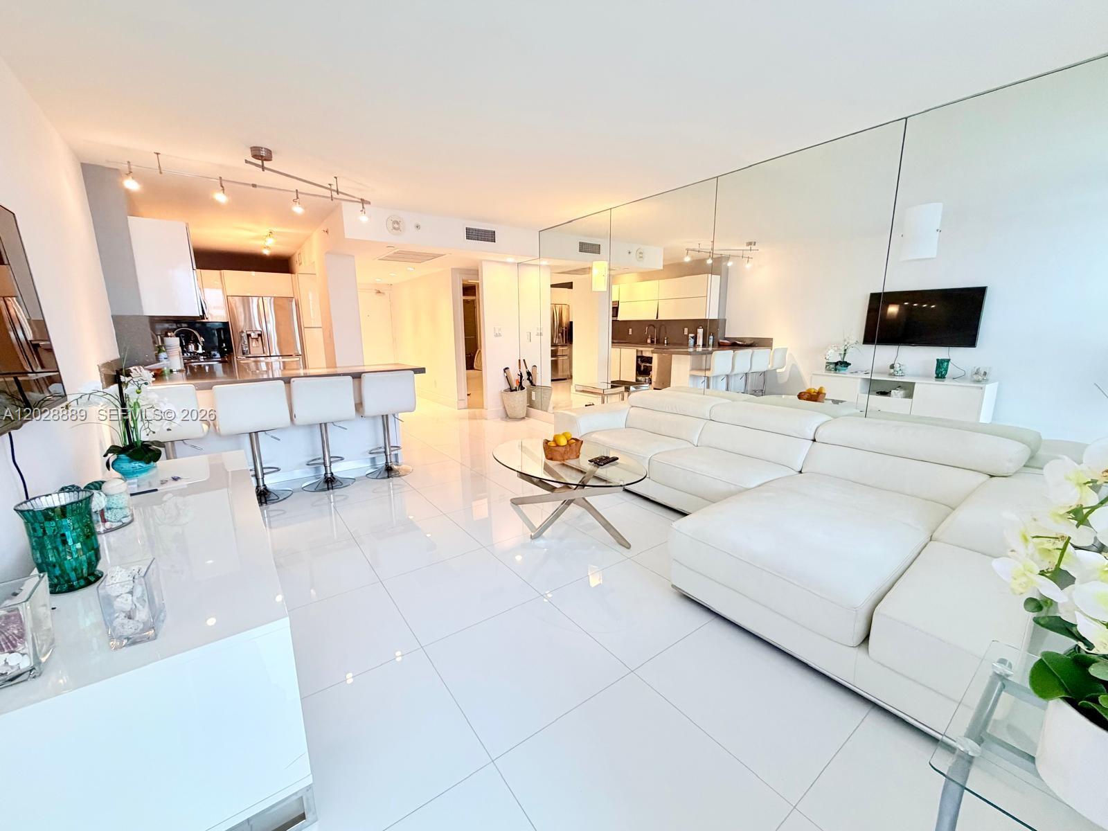 100 Lincoln Road, Unit 1504 Miami Beach, FL 33139 - Photo 1 of 17 a living room with furniture and a flat screen tv