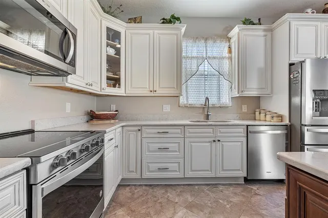 a view of staircase with lots of frames on wall and a window