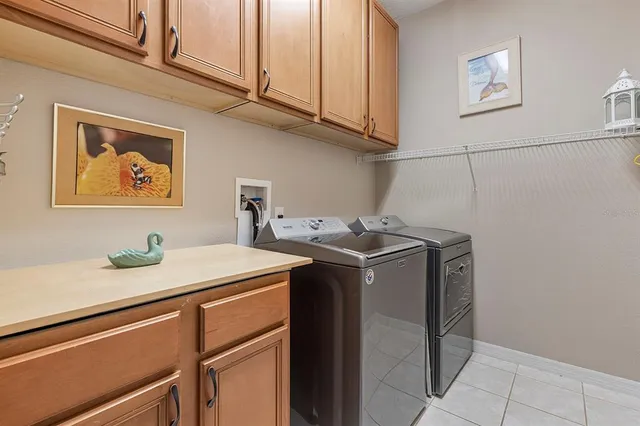 a view of yard with green space and trees in the background