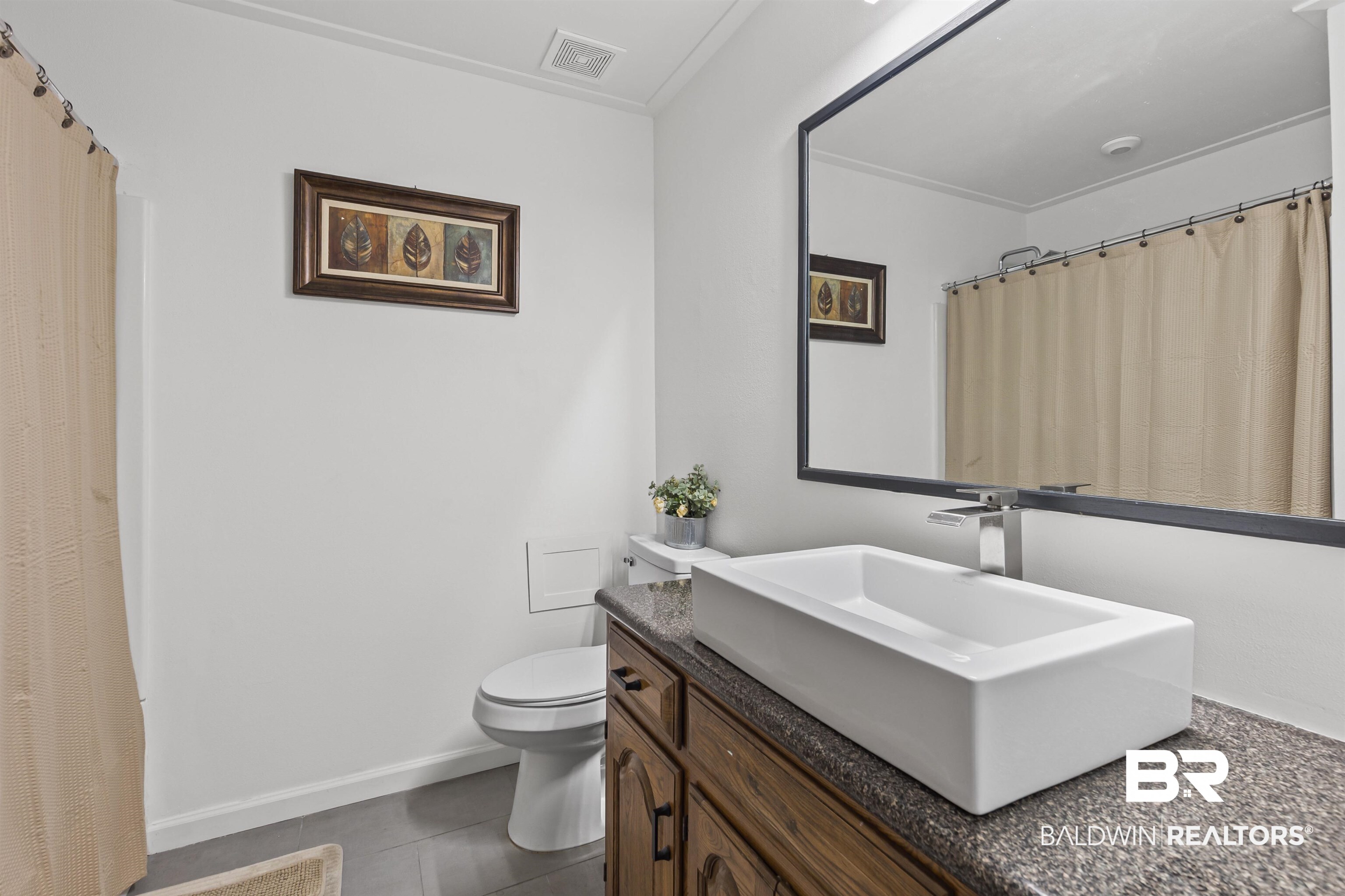 8911 Owassa Road Evergreen, AL 36401 - Photo 18 of 24 Full bathroom with vanity, dark tile patterned flooring, and a shower with curtain