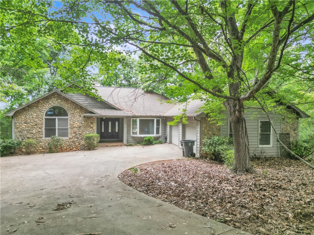149 Inlet Pointe Drive Anderson, SC 29625 - Photo 1 of 43 A stone and wood-sided residence nestled among lush mature trees welcomes you home.