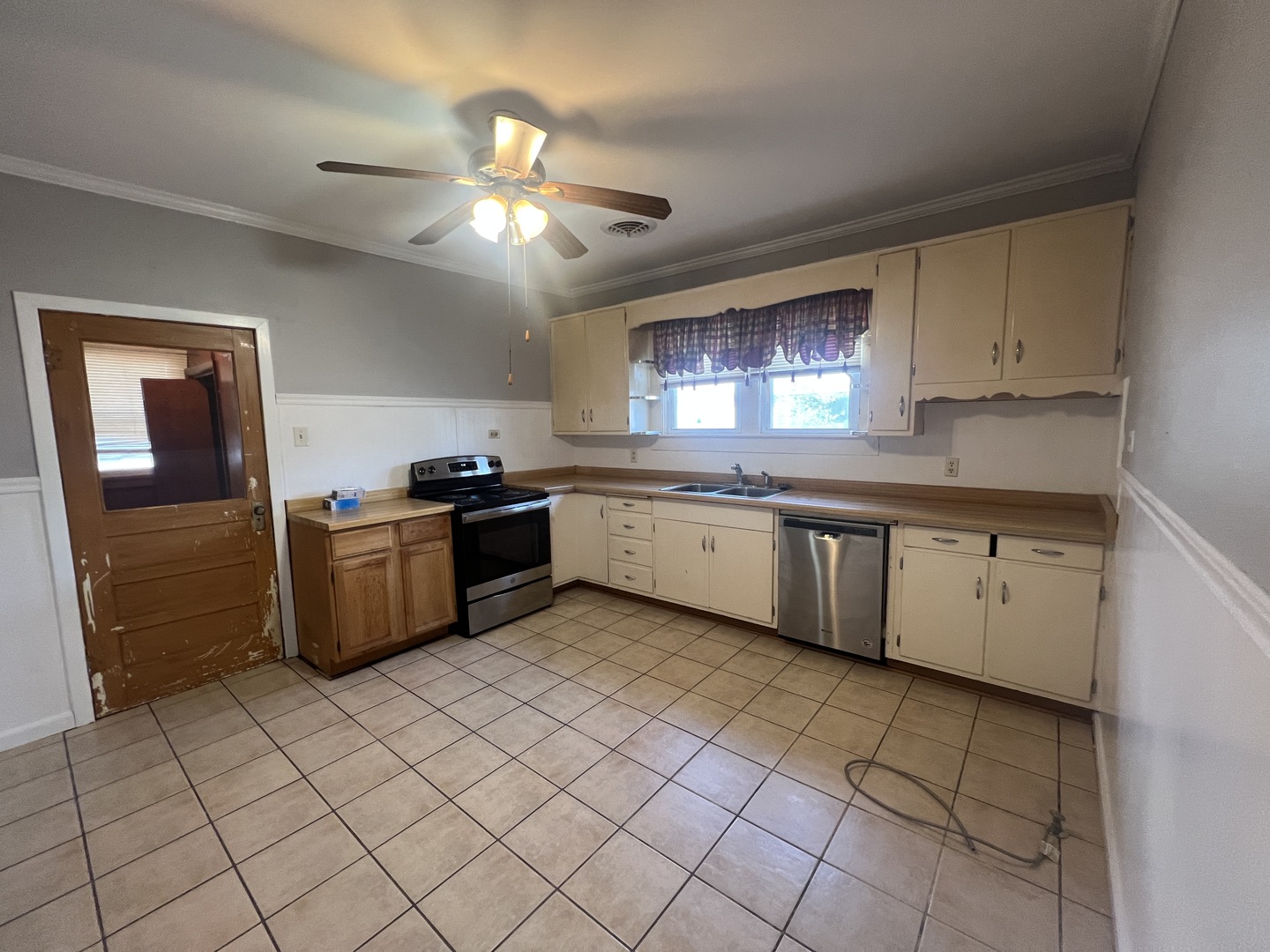 1109 West Adams Street Herrin, IL 62948 - Photo 13 of 27 a kitchen with a sink window and cabinets