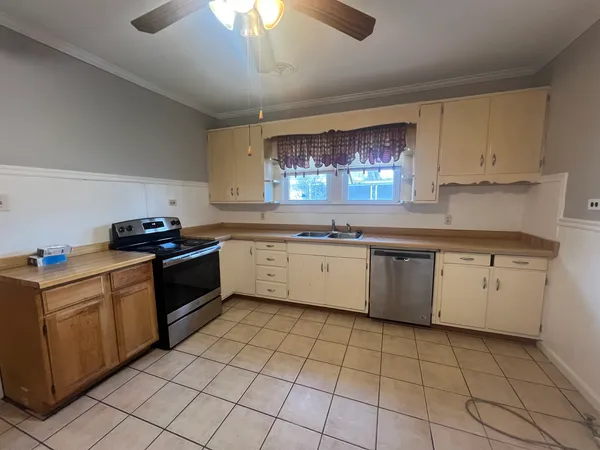 a kitchen with a sink window and cabinets