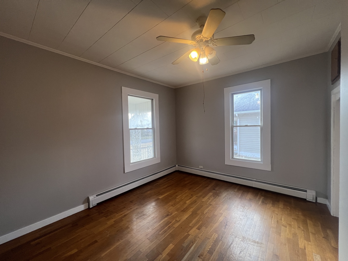 1109 West Adams Street Herrin, IL 62948 - Photo 16 of 27 an empty room with wooden floor and windows
