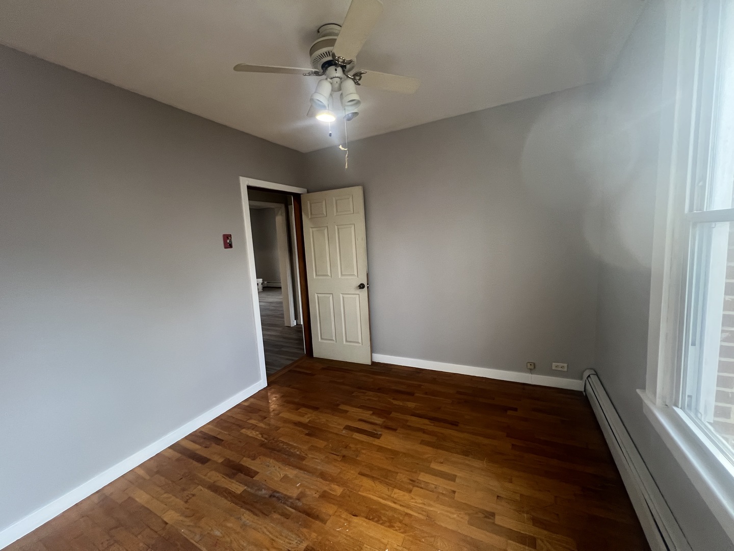 1109 West Adams Street Herrin, IL 62948 - Photo 19 of 27 an empty room with wooden floor and windows
