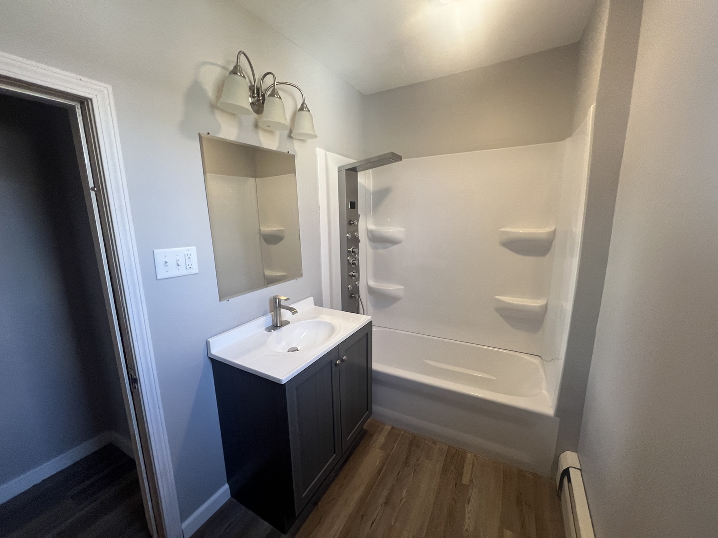 1109 West Adams Street Herrin, IL 62948 - Photo 21 of 27 a bathroom with a sink a mirror and a shower