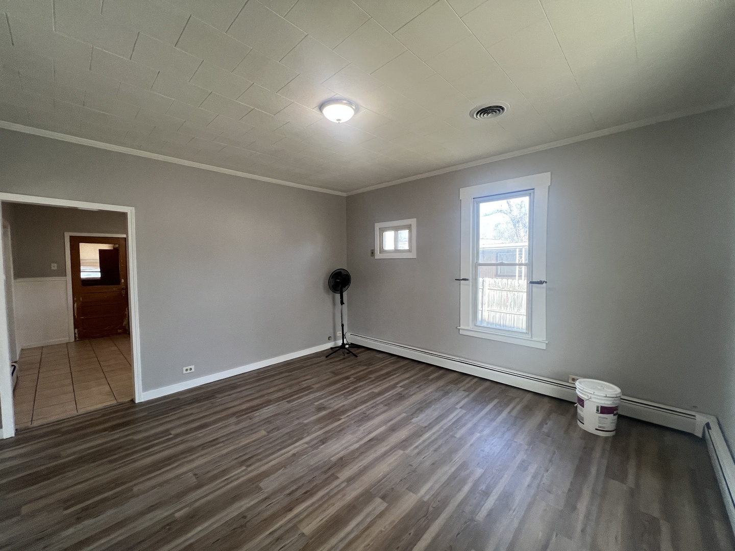 1109 West Adams Street Herrin, IL 62948 - Photo 10 of 27 an empty room with wooden floor and windows