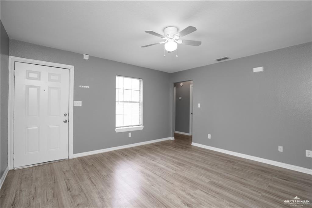 1918 Angus Street, Unit 3 Mission, TX 78572 - Photo 3 of 15 a view of an empty room with a window and wooden floor