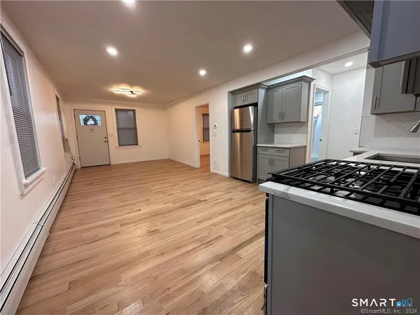 a kitchen with stainless steel appliances granite countertop a stove and a refrigerator