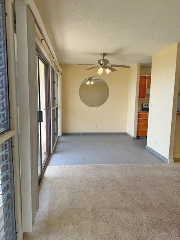 a view of an empty room and a bathroom