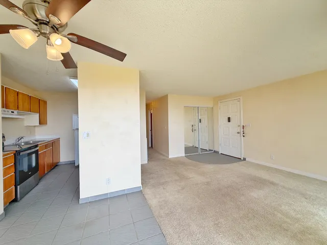 a view of a kitchen with a sink and a refrigerator