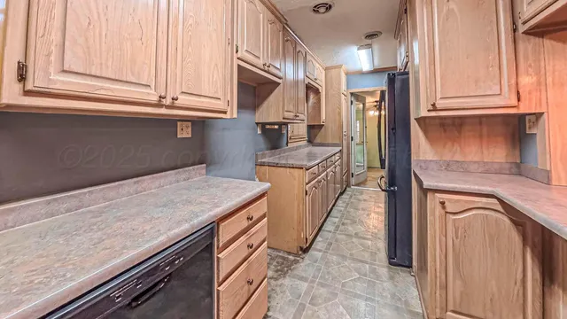 a kitchen with stainless steel appliances granite countertop a sink and a stove
