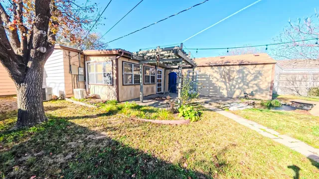 a view of a house with a yard patio and swimming pool