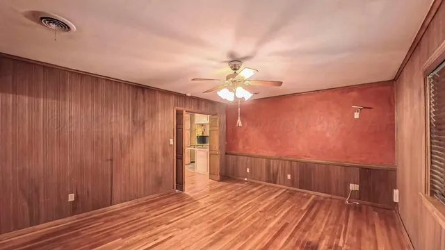 wooden floor in an empty room with a window
