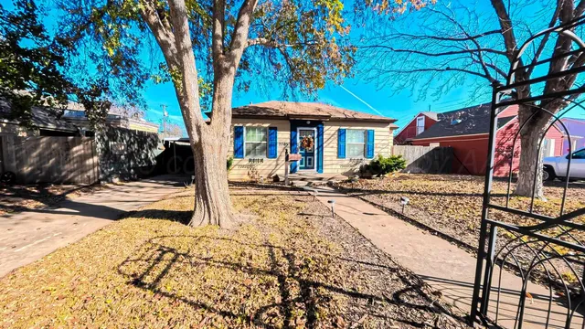 a front view of a house with yard and patio