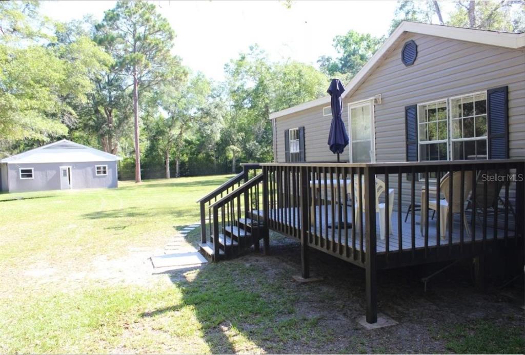 3391 Rackley Road Brooksville, FL 34604 - Photo 1 of 1 a view of a house with backyard and deck
