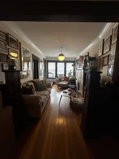 a living room with furniture and a floor to ceiling window