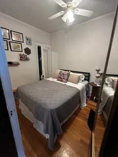 a bedroom with a bed and painting on the wall