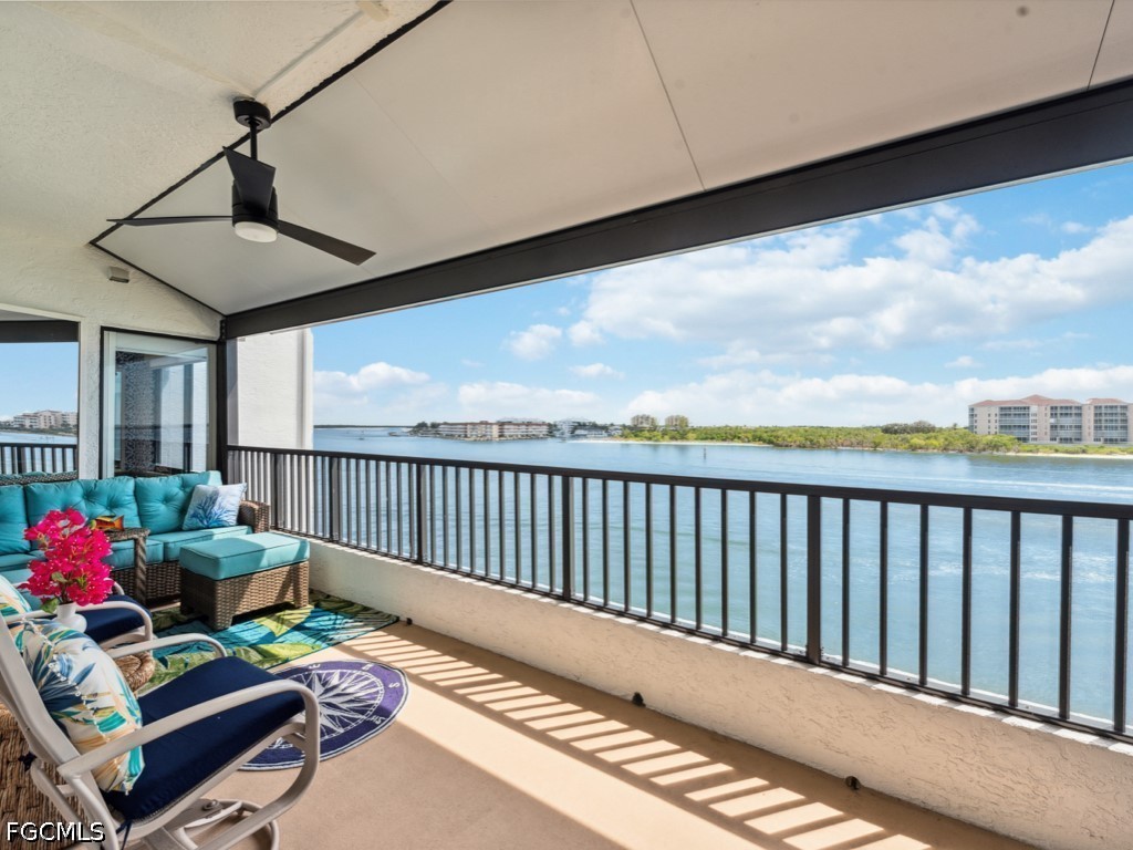 232 La Peninsula Boulevard, Unit 232 Naples, FL 34113 - Photo 25 of 44 a balcony with furniture and a potted plant