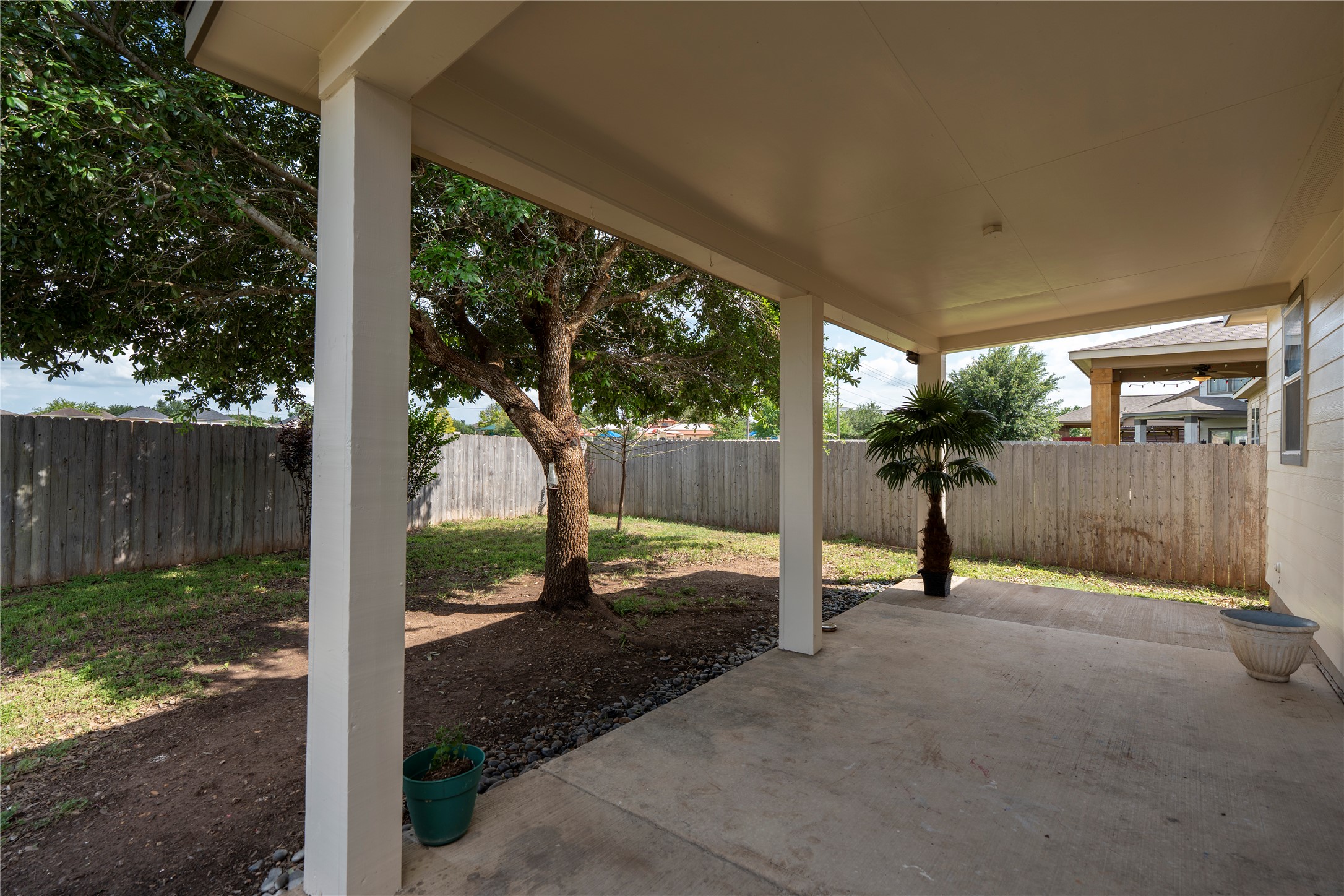 8613 Capitol View Drive Austin, TX 78747 - Photo 27 of 33 A spacious covered patio invites relaxation with a view of the fenced yard and mature trees.
