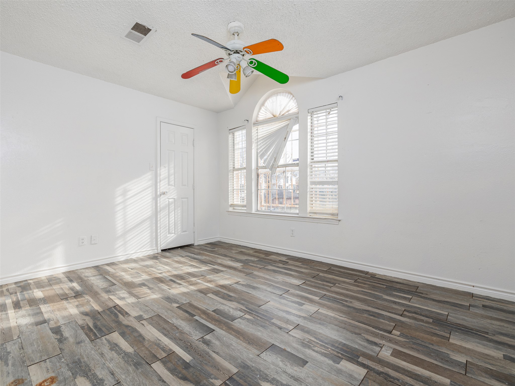 506 Tillery Street Austin, TX 78702 - Photo 12 of 27 Unfurnished room with wood finished floors and ceiling fan