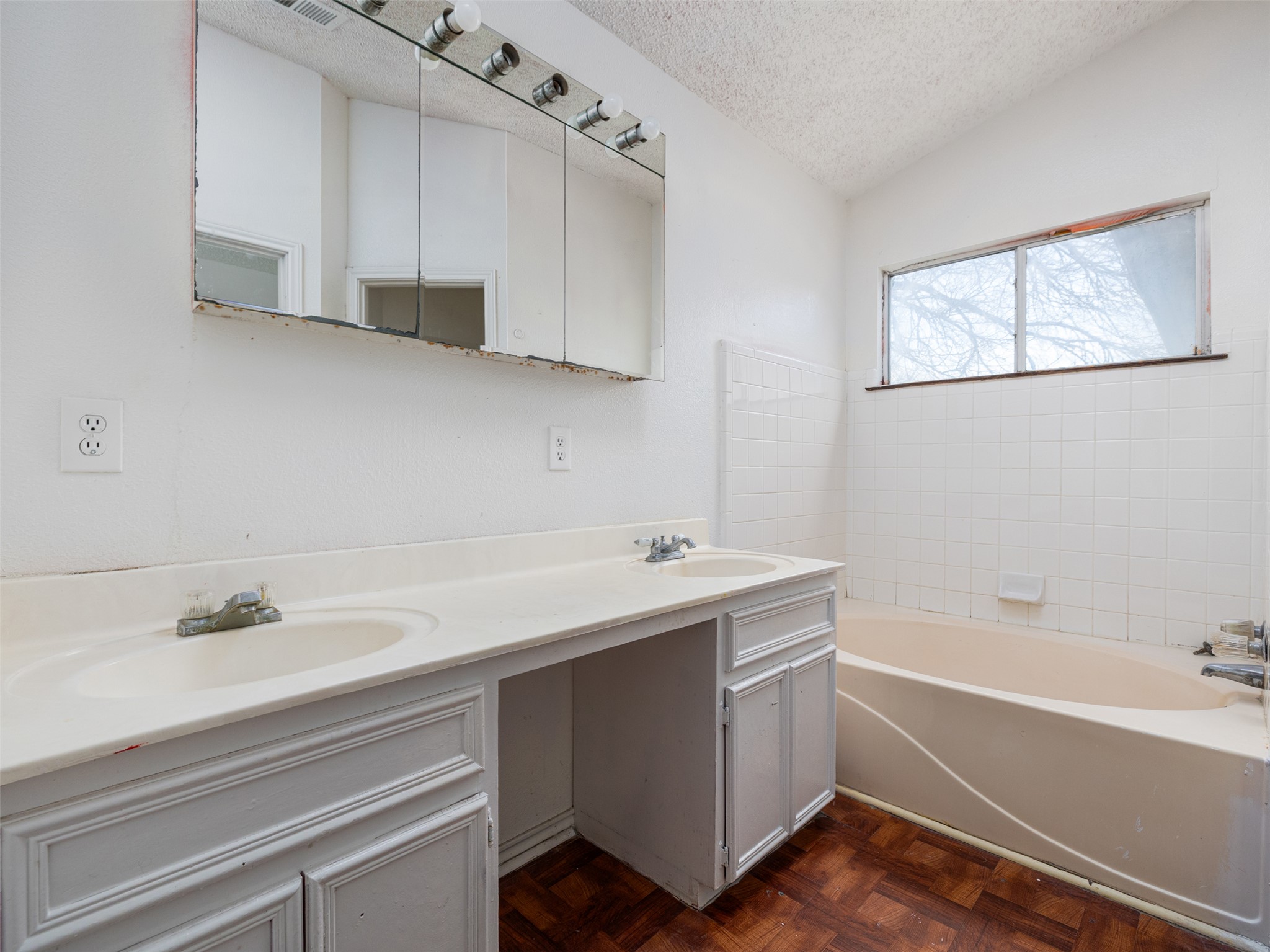 506 Tillery Street Austin, TX 78702 - Photo 10 of 27 Bathroom featuring double vanity and parquet flooring