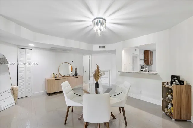 a view of a dining room with furniture and a chandelier fan
