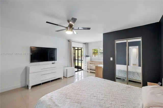 a bedroom with furniture and a flat screen tv
