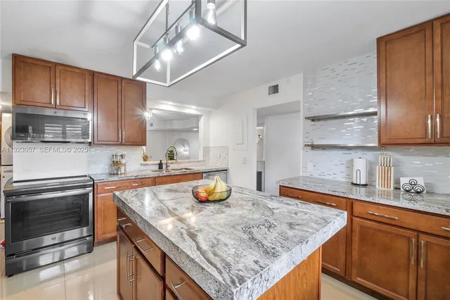 a kitchen with a sink a stove and cabinets
