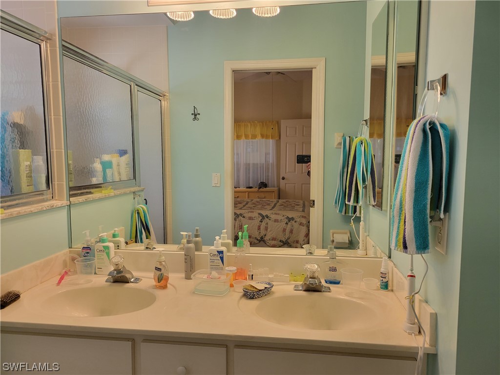 10720 Blue Bimini Circle Estero, FL 33928 - Photo 14 of 28 a bathroom with a sink and a mirror