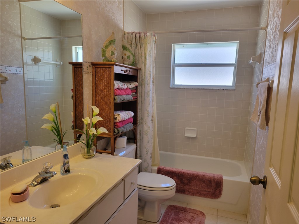 10720 Blue Bimini Circle Estero, FL 33928 - Photo 16 of 28 a bathroom with a sink toilet and shower