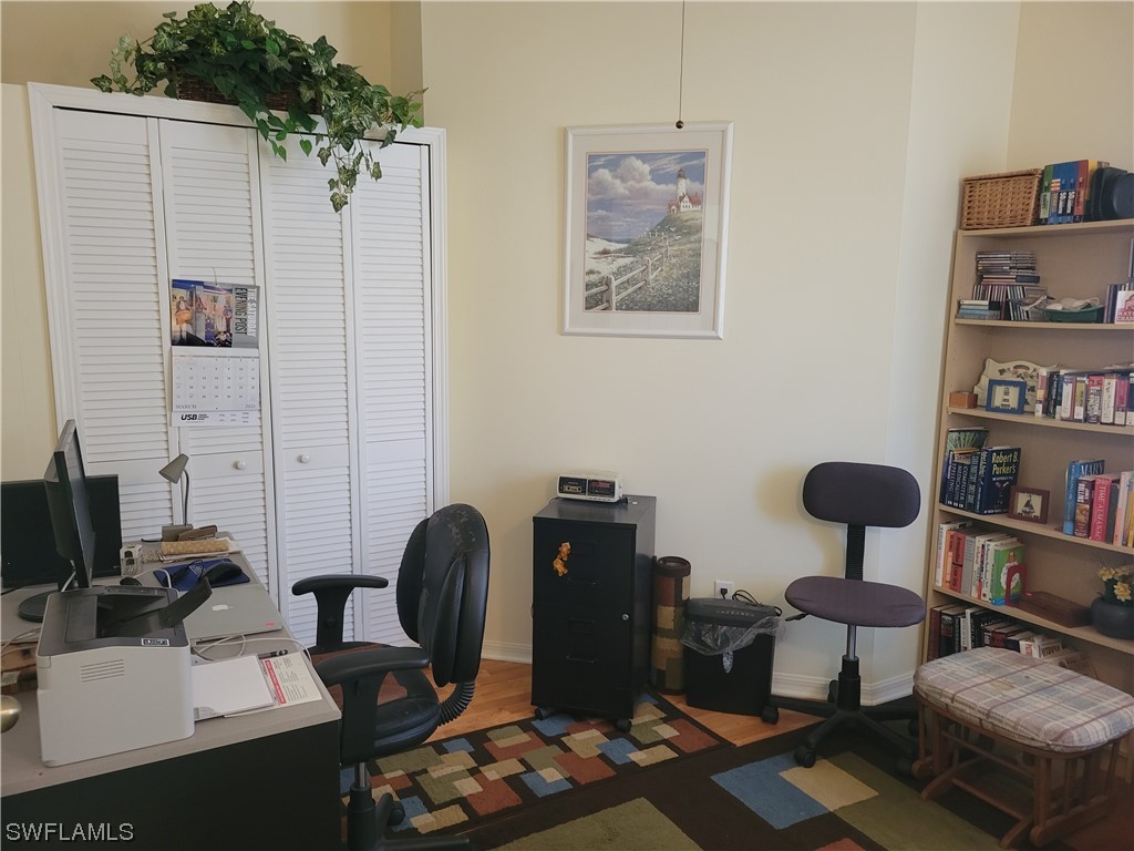 10720 Blue Bimini Circle Estero, FL 33928 - Photo 18 of 28 a room with furniture and wooden floor