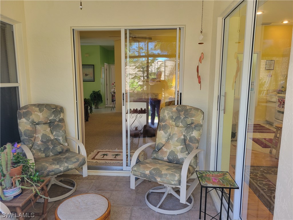 10720 Blue Bimini Circle Estero, FL 33928 - Photo 21 of 28 a living room with furniture and a large window