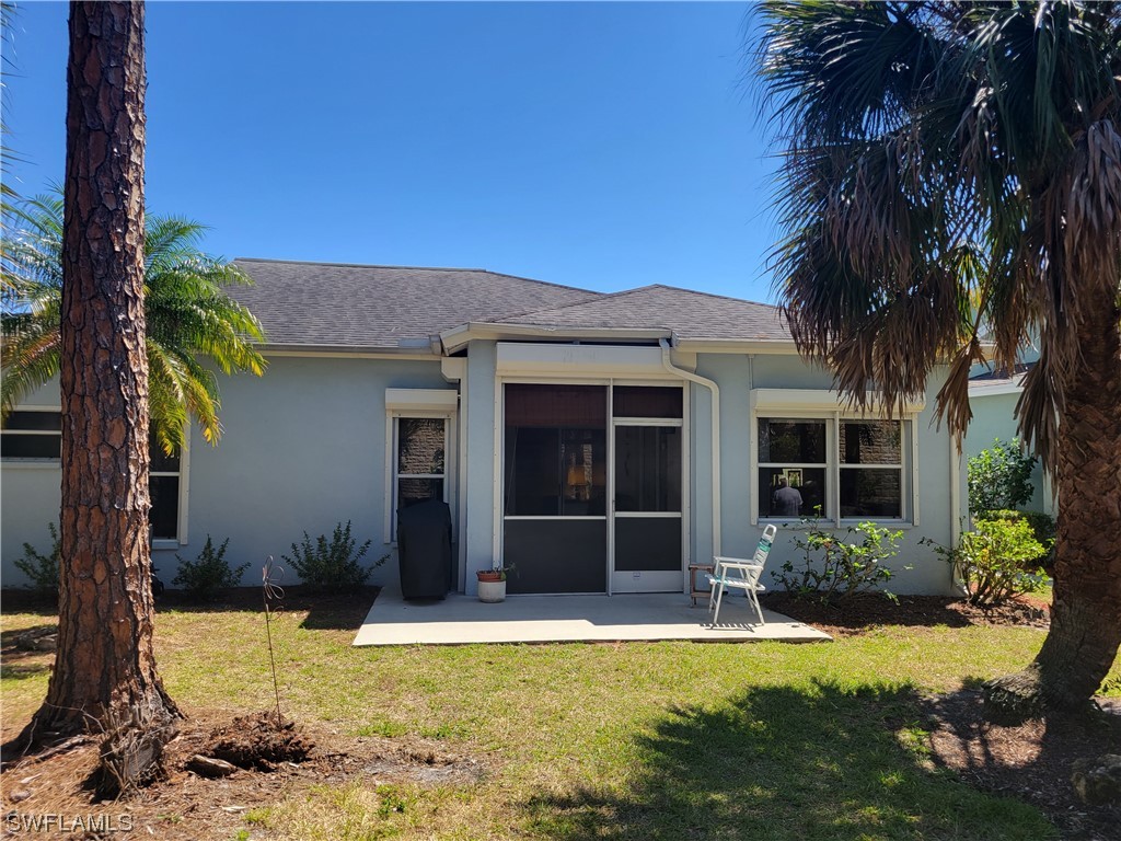 10720 Blue Bimini Circle Estero, FL 33928 - Photo 23 of 28 a front view of a house with a yard