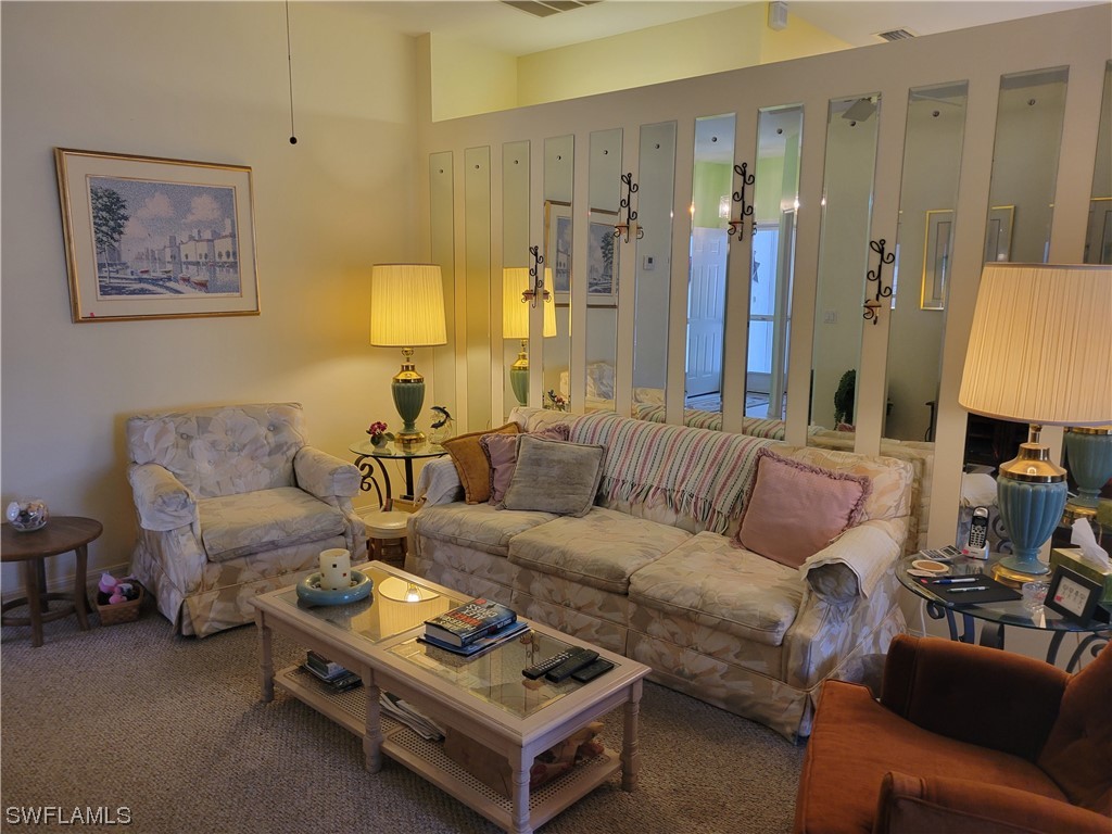 10720 Blue Bimini Circle Estero, FL 33928 - Photo 3 of 28 a living room with furniture and a lamp