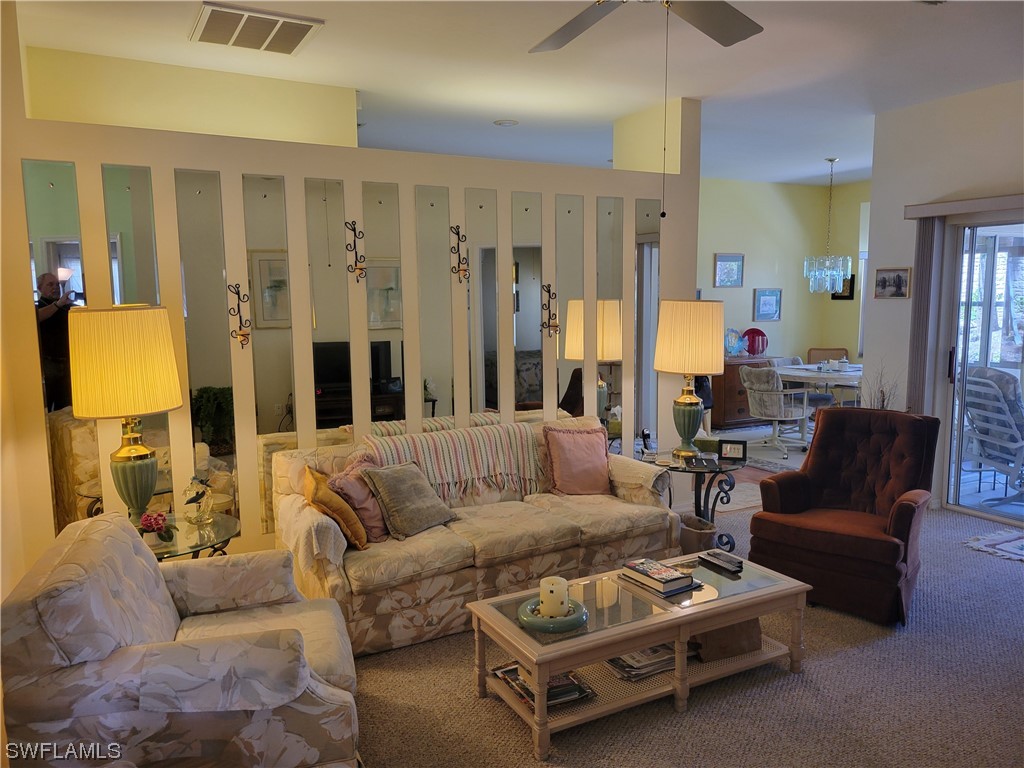 10720 Blue Bimini Circle Estero, FL 33928 - Photo 4 of 28 a living room with furniture and a large window