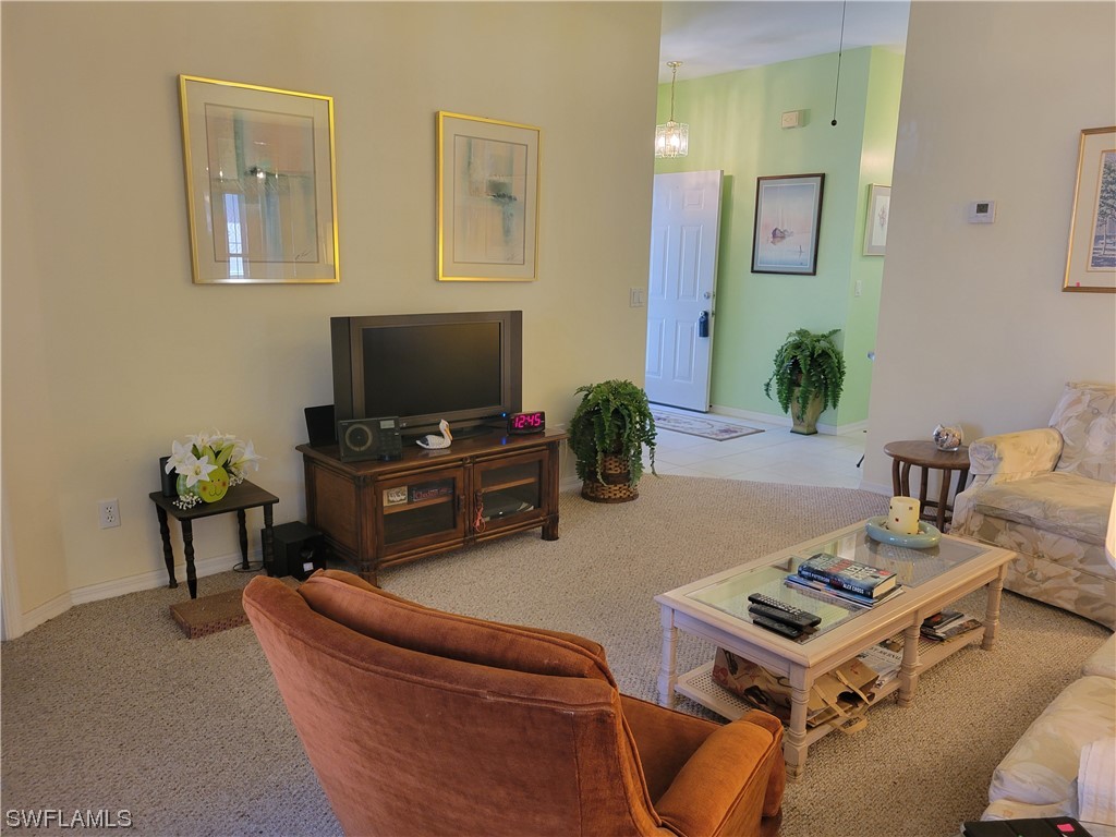 10720 Blue Bimini Circle Estero, FL 33928 - Photo 5 of 28 a living room with furniture and a flat screen tv