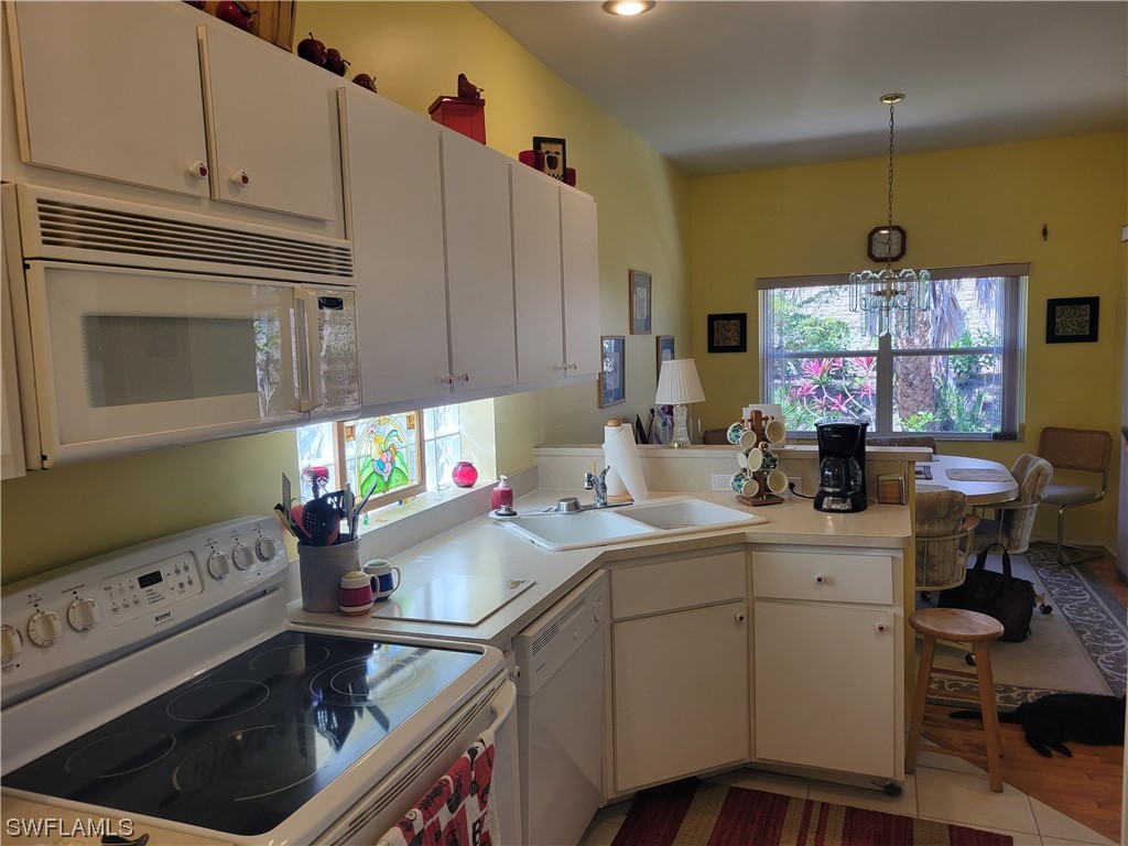 10720 Blue Bimini Circle Estero, FL 33928 - Photo 9 of 28 a kitchen with a sink cabinets and window