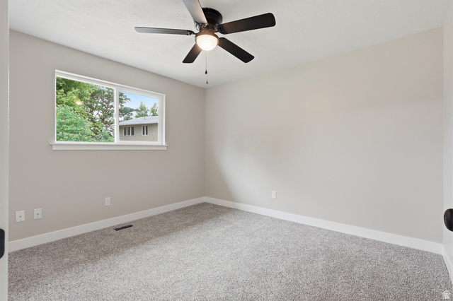 629 King Circle Layton, UT 84041 - Photo 13 of 26 Carpeted room with neutral wall paint and white trim