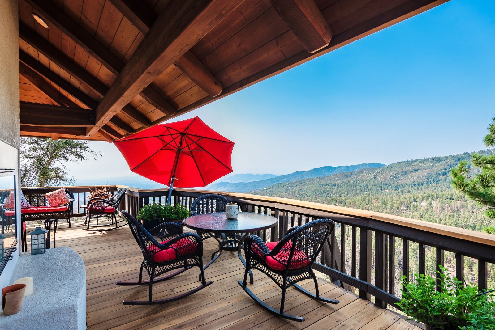 52430 Double View Drive Idyllwild, CA 92549 - Photo 43 of 75 a living room with furniture a flat screen tv and a floor to ceiling window