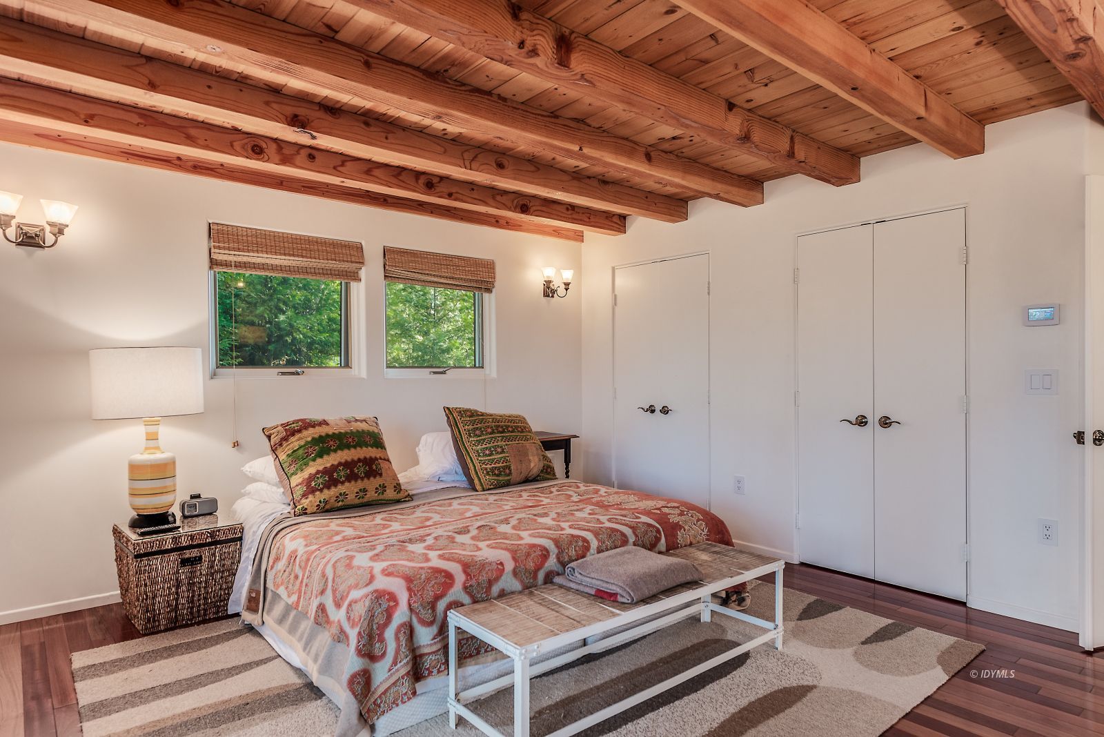 52430 Double View Drive Idyllwild, CA 92549 - Photo 53 of 75 a bedroom with a large bed and a lamp on dresser