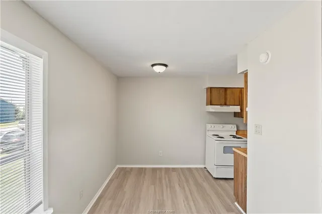 a kitchen with a stove and a refrigerator