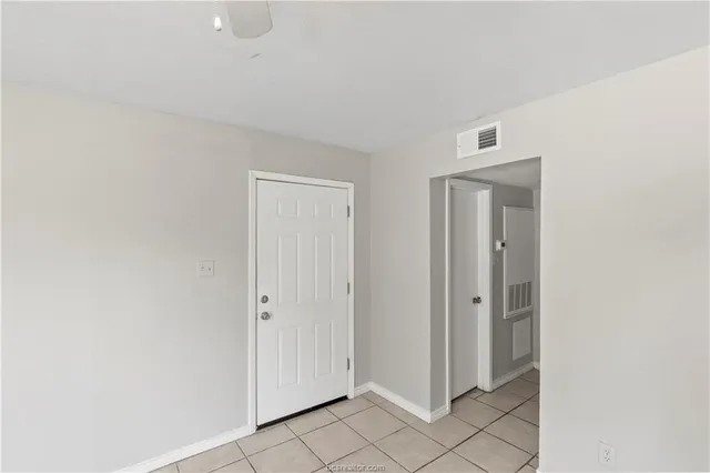 a view of a livingroom and an empty room