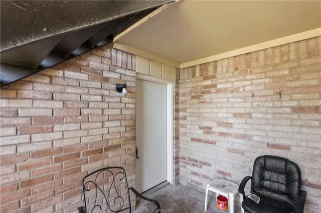 a view of an empty room and chandelier fan