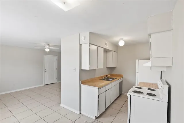 a kitchen that has a sink and a stove